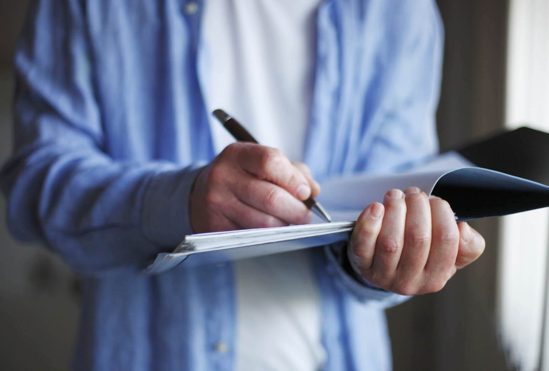 A person writing something in her notebook