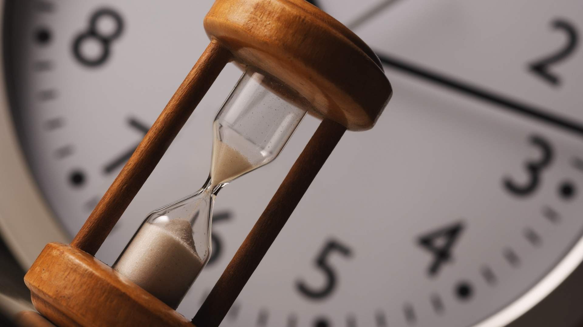 an hour glass and a clock