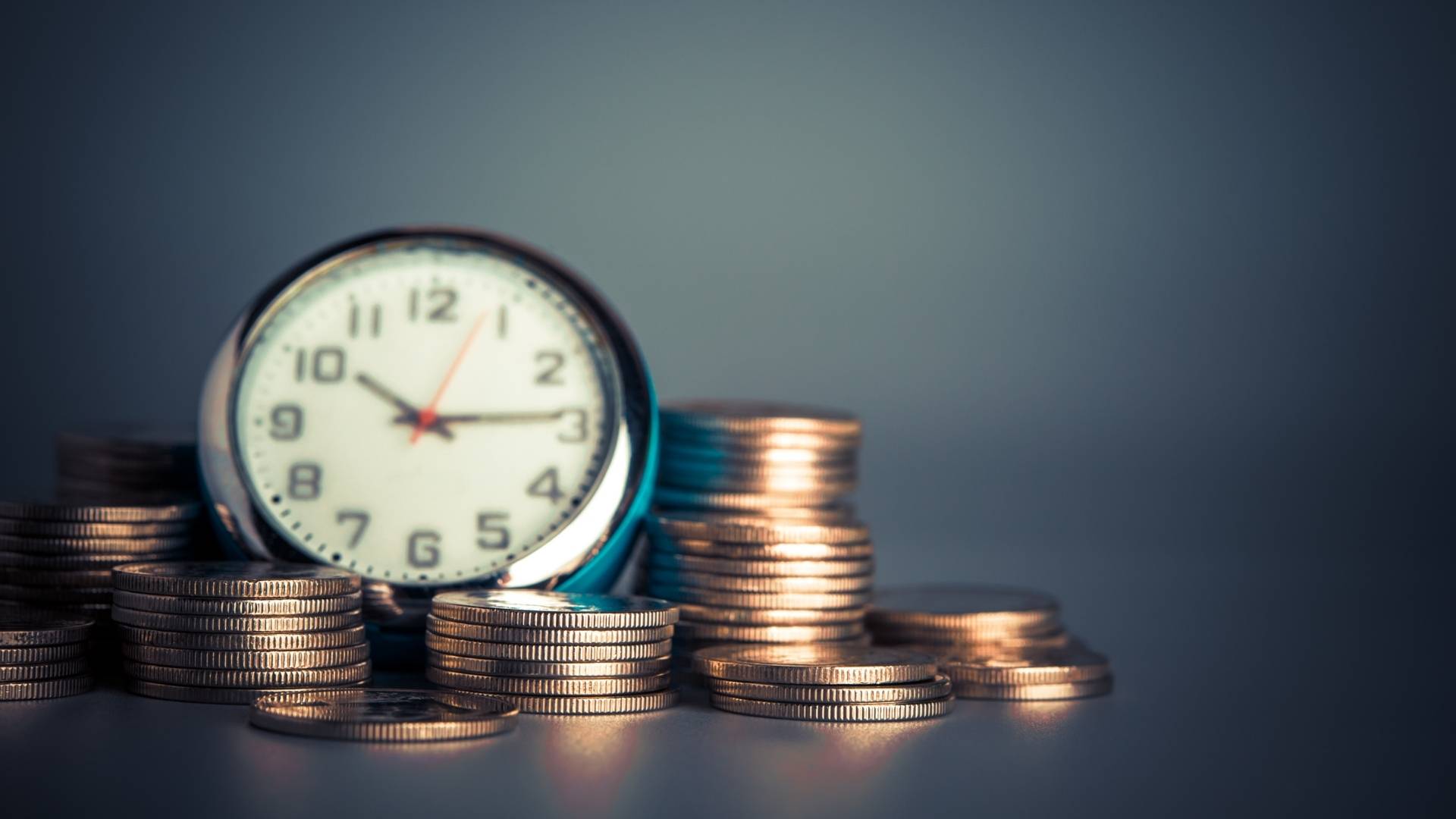 clock and coins on the table