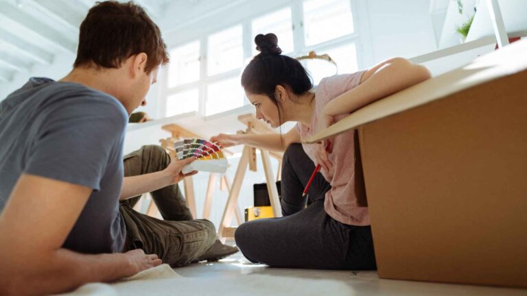 couple choosing the right color for wall paint