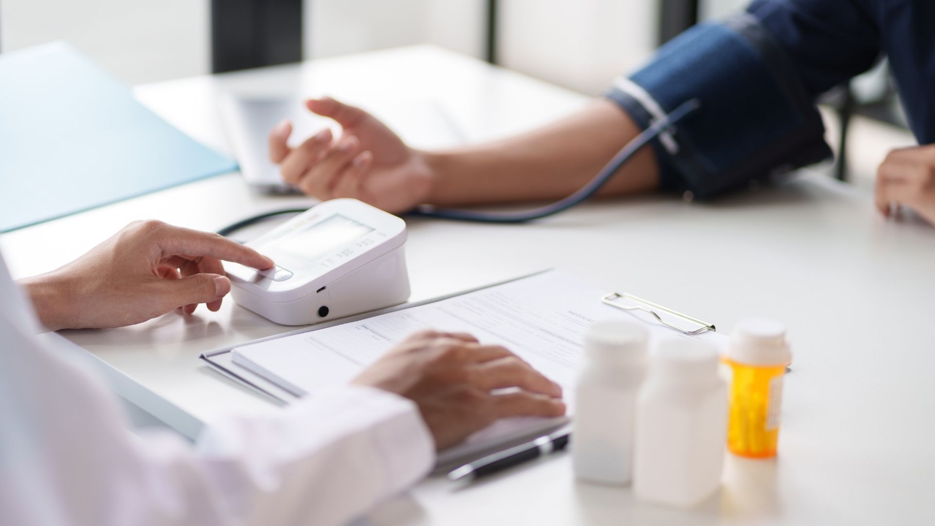 doctor taking a patient's blood pressure