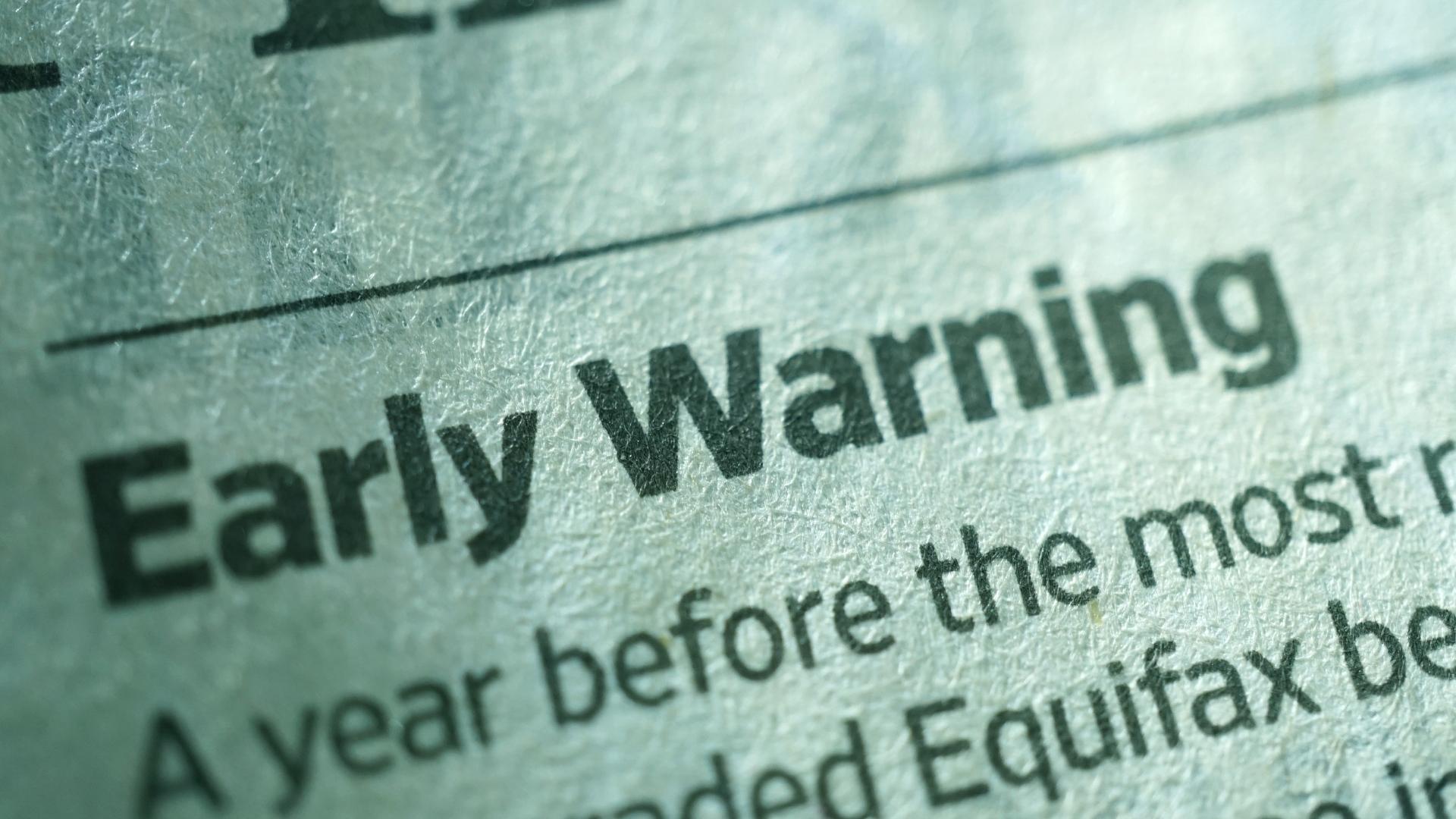 early warning word written in an old newspaper