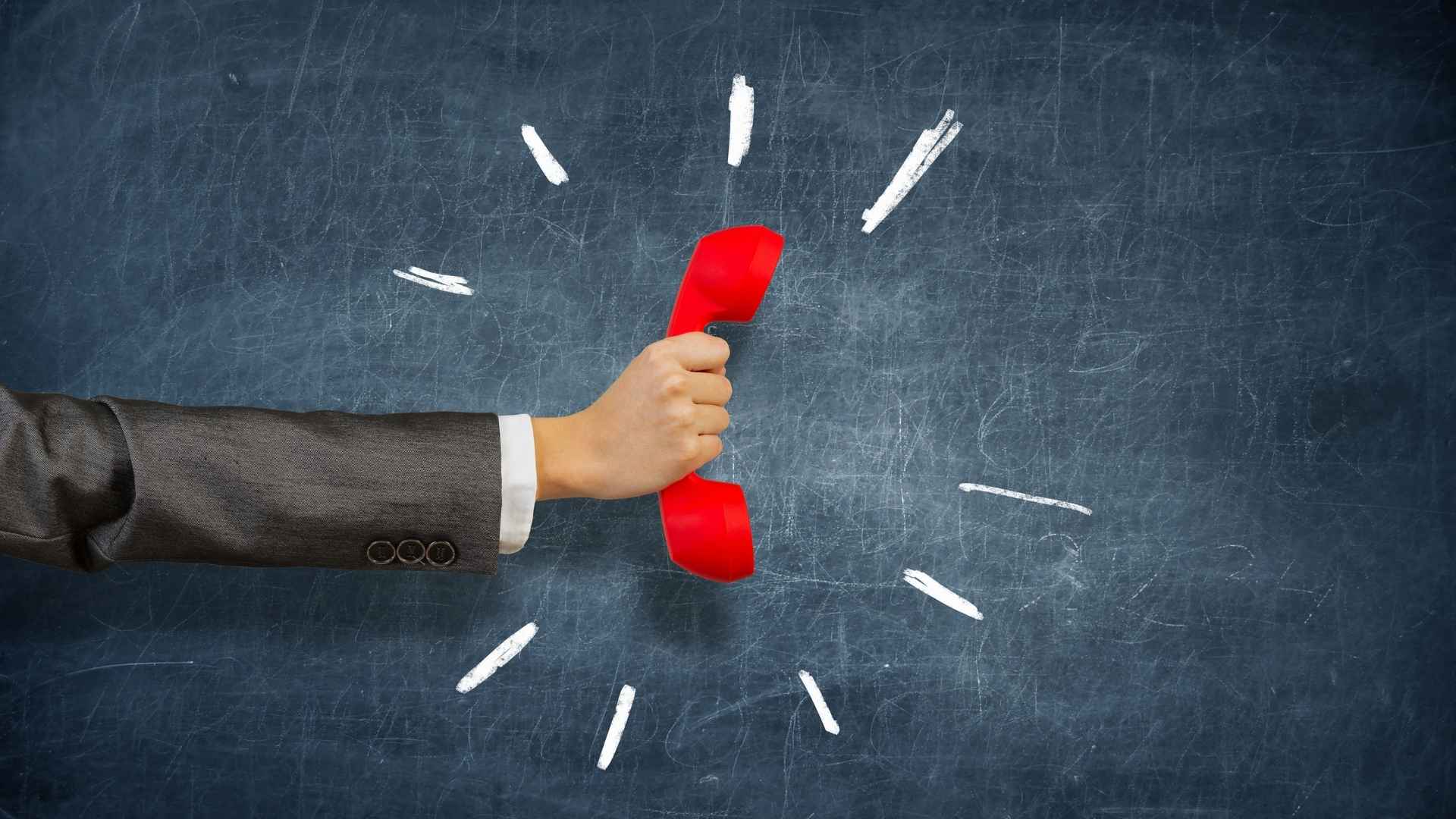 gentleman holding a red phone