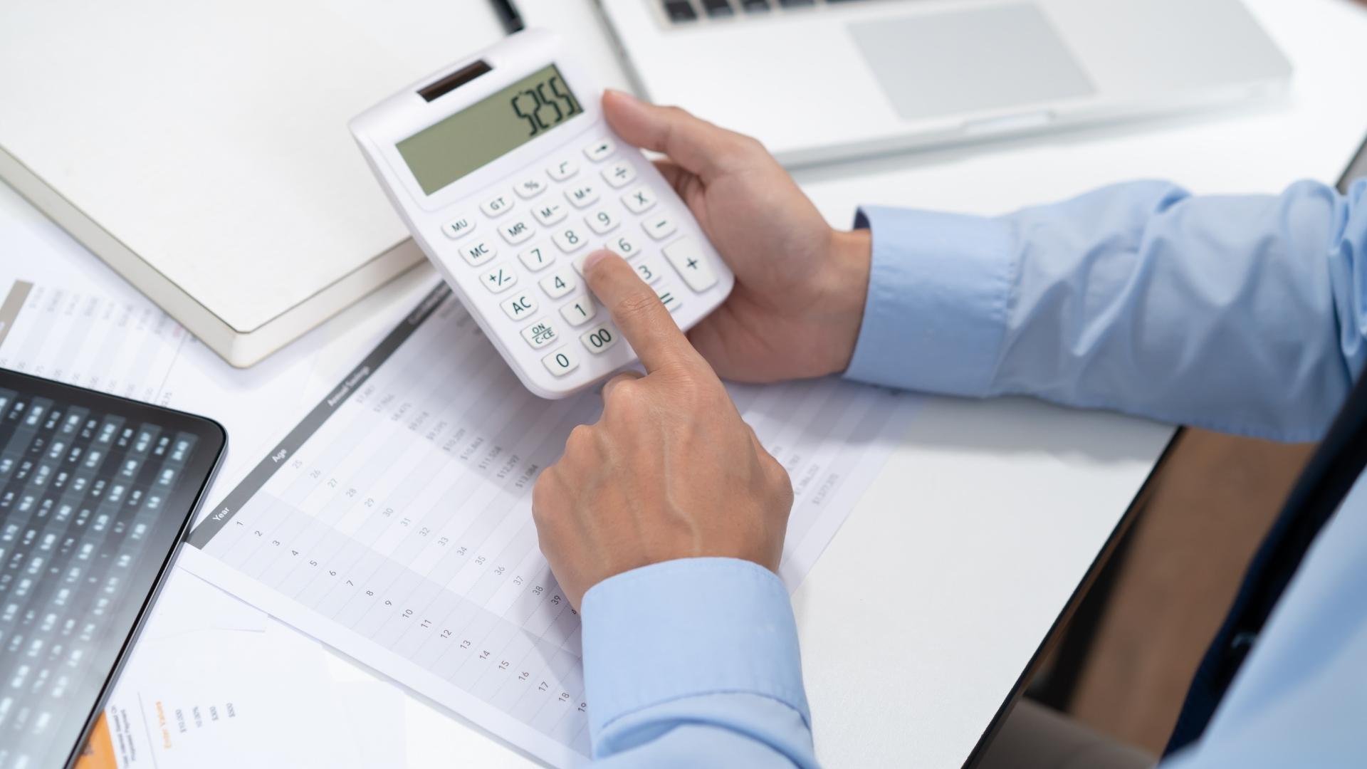 guy using calculator for computing profit