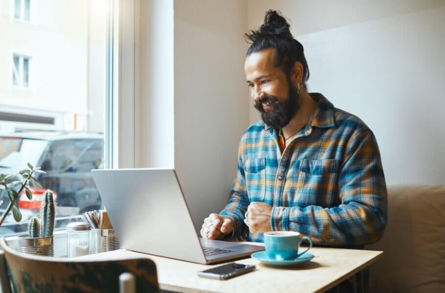 Men in front of her laptop with coffee
