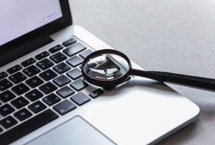 Magnifying glass above in laptop