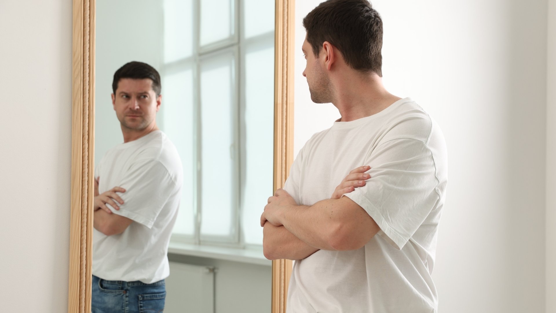 man looking his self in a mirror