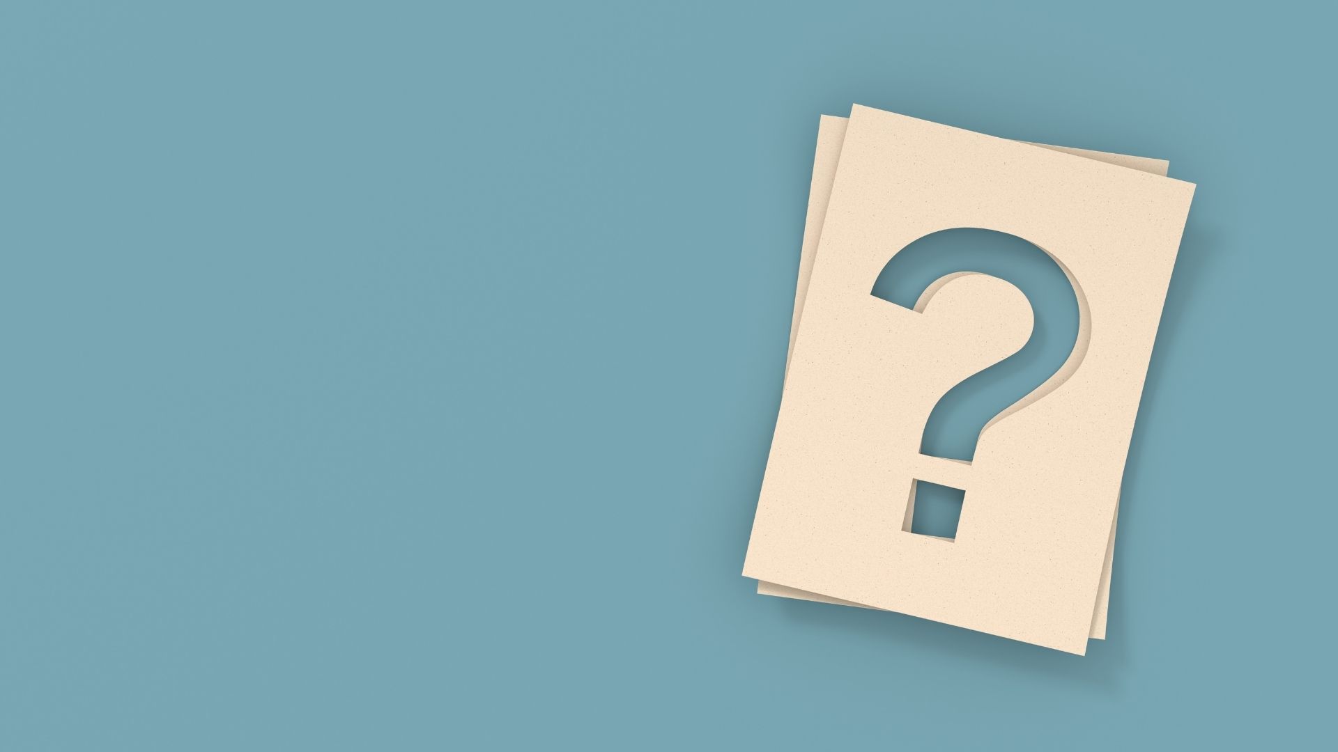 question mark written in cardboard in blue background