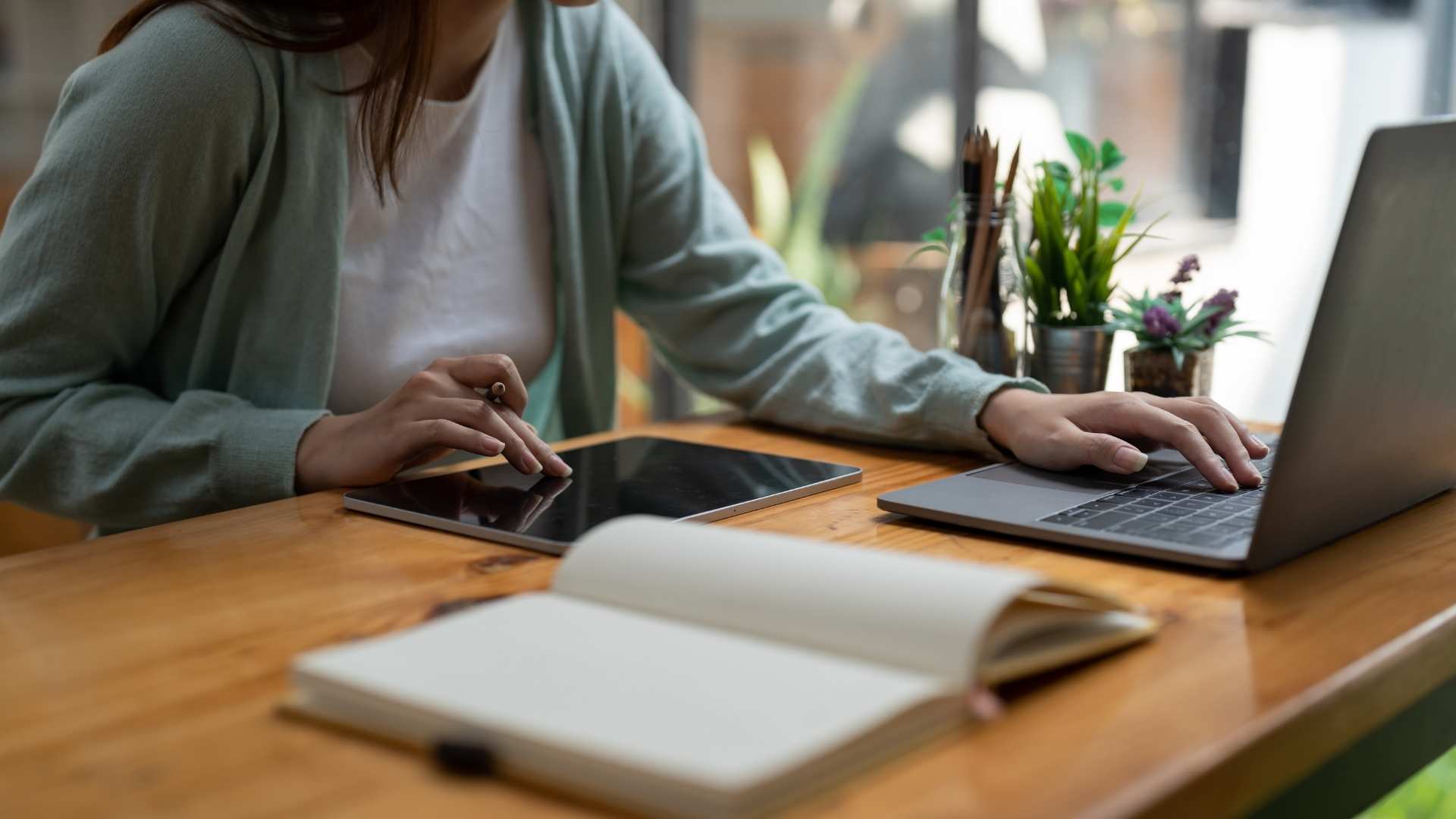 woman taking notes on her tablet and browsing