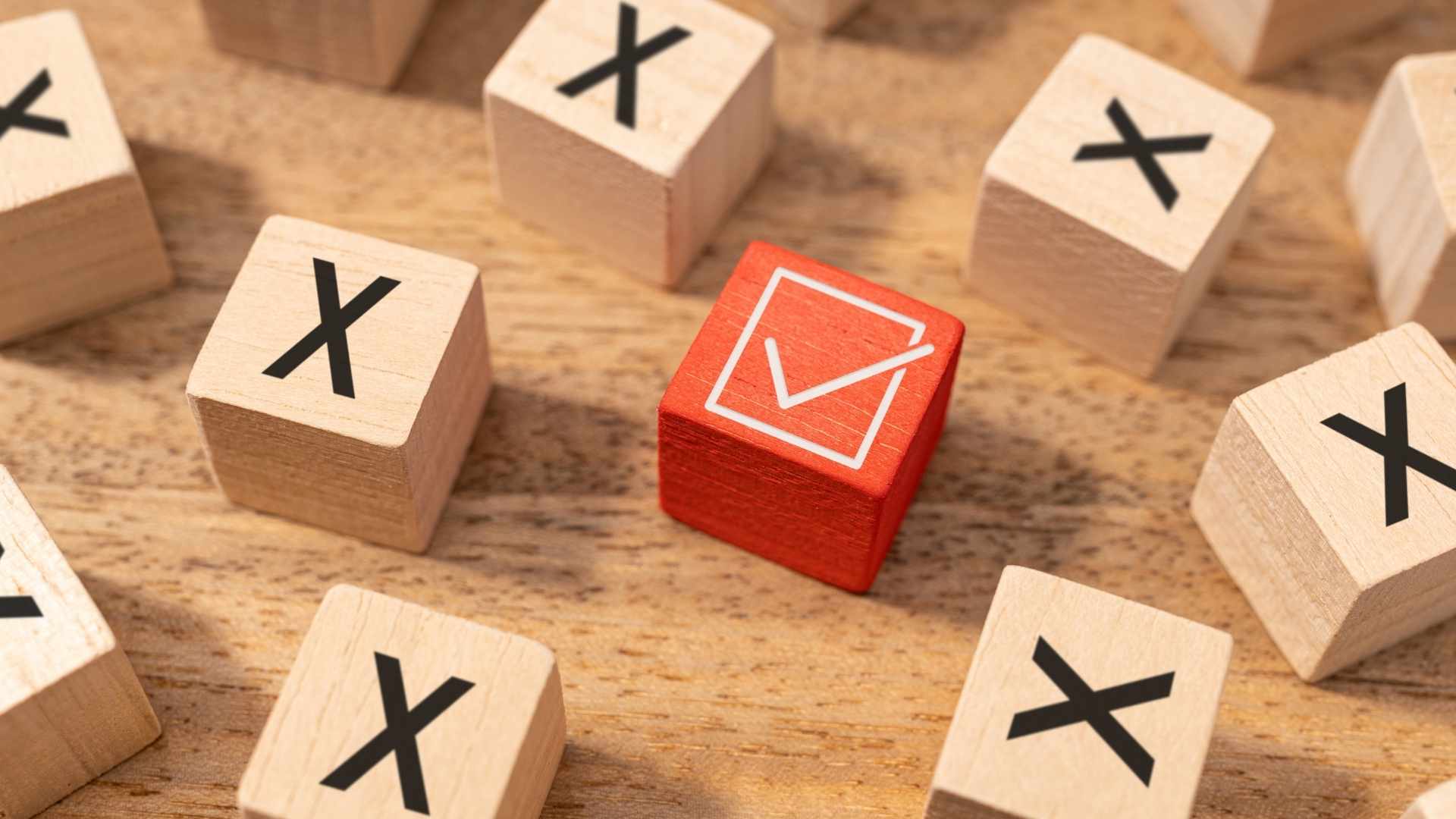 wooden blocks with a red checkmark and x-mark