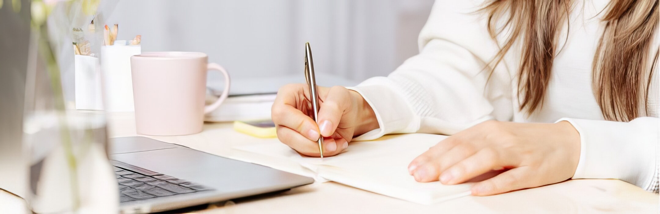 person writing down things on paper