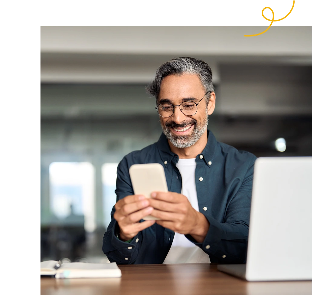 A happy man using a phone