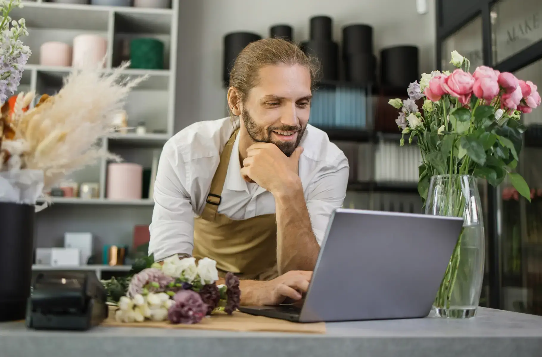 florist looking at his laptop for possible customers