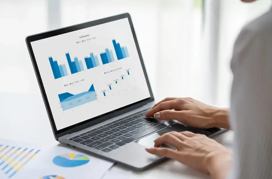 Person analyzing graphs and charts on a laptop