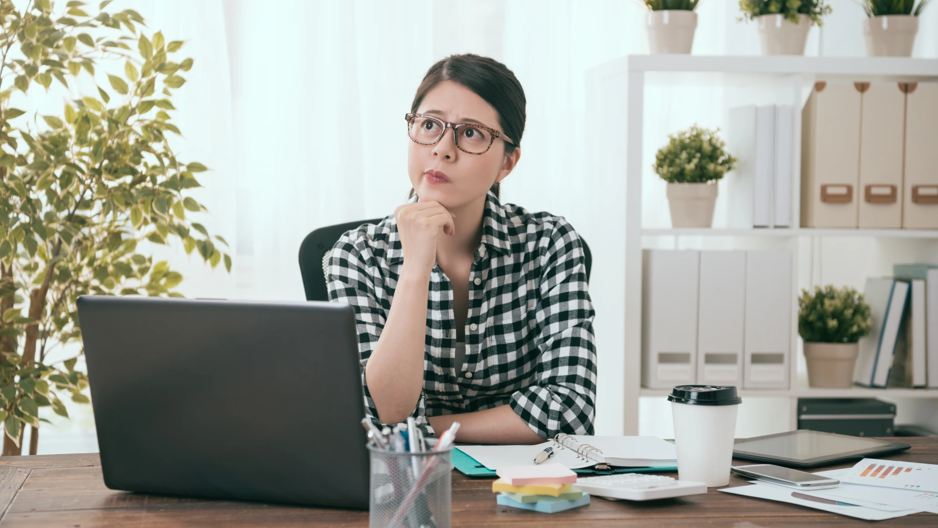 Pretty young business woman worker working at home and having difficulty problem looking at air daydreaming to think solution.