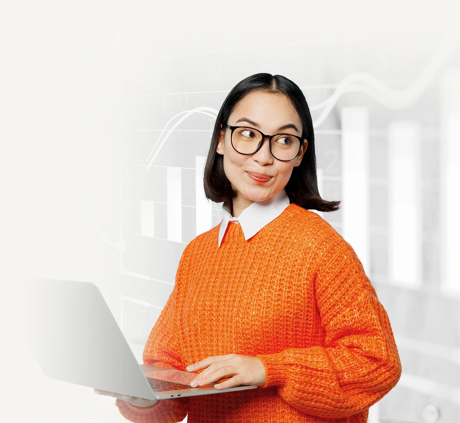 Side view of a young, happy Asian woman wearing an orange sweater and glasses, holding a laptop