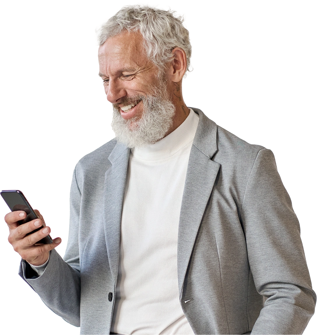 Smiling older man with a beard looking at his phone