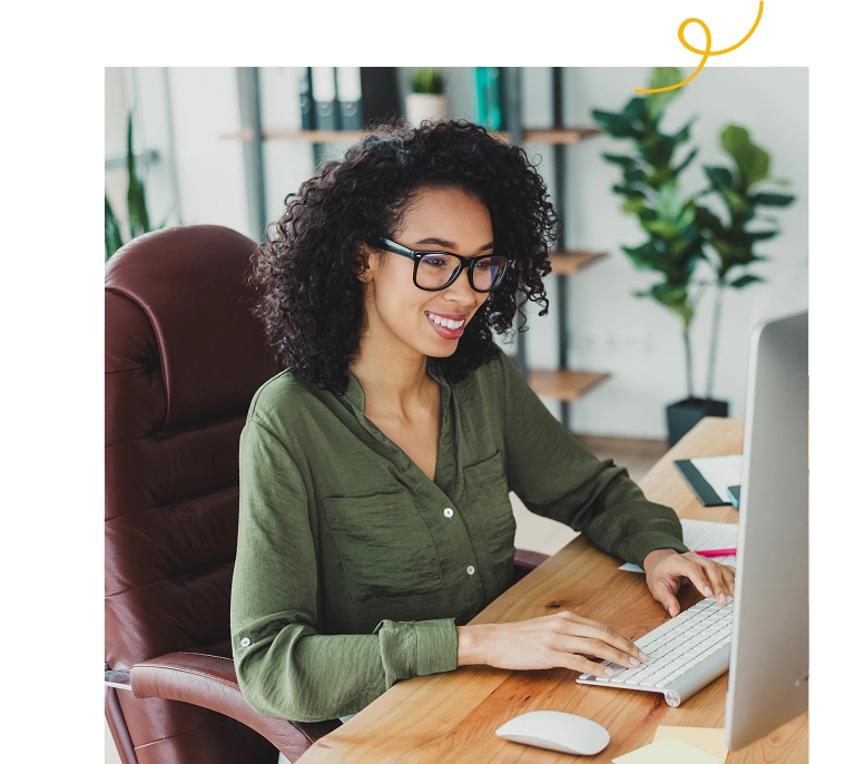 Smiling woman working at a computer in an office